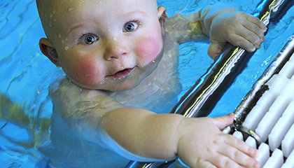 A baby in a swimming pool.