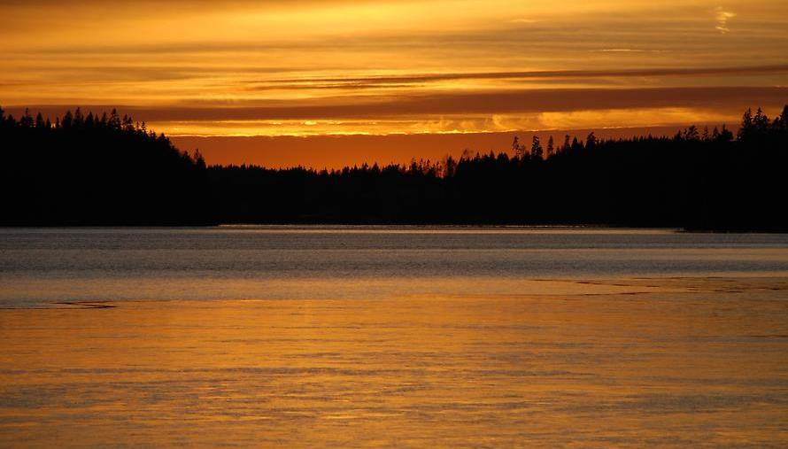 Solnedgång över sjö.