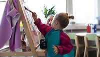 Ett barn som målar med en pensel