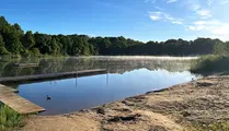 Sol och dis över sjön Kolbränningen. 